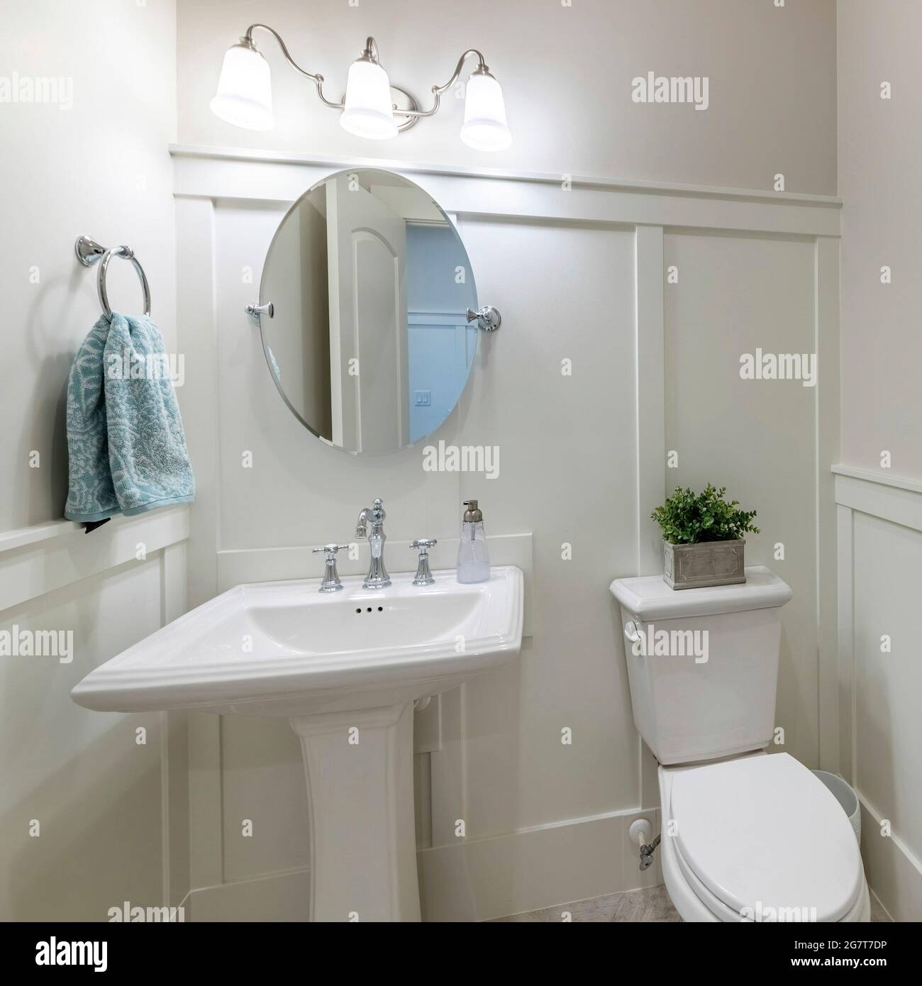 Square frame Interior of a powder room with half wooden panel and lights Stock Photo
