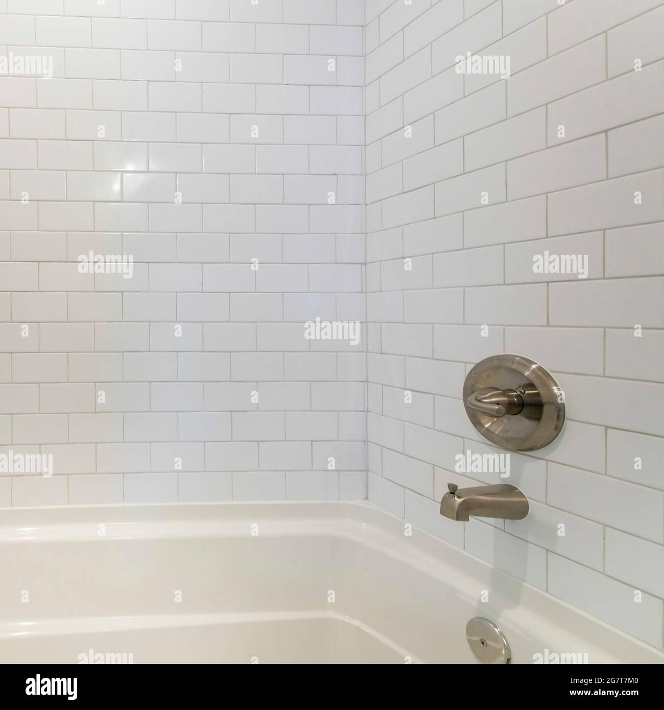 Square frame Inside a bathtub with subway tiles wall and stainless ...