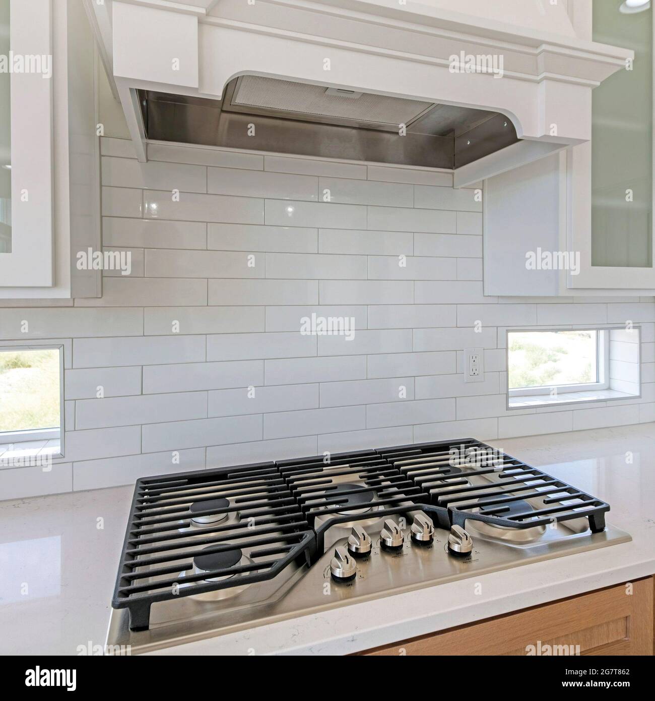 Square frame White kitchen counter with builtin gas cooktop with