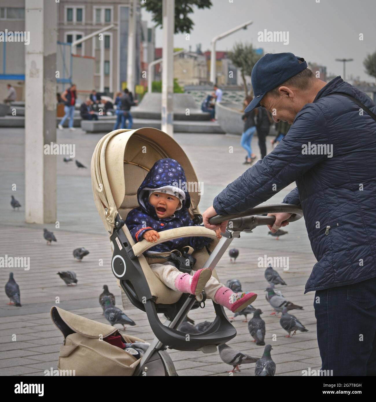 A Chinese tourist with a cheerful baby in Taksim Square/Turkey, Istanbul, Taksim Square Stock Photo