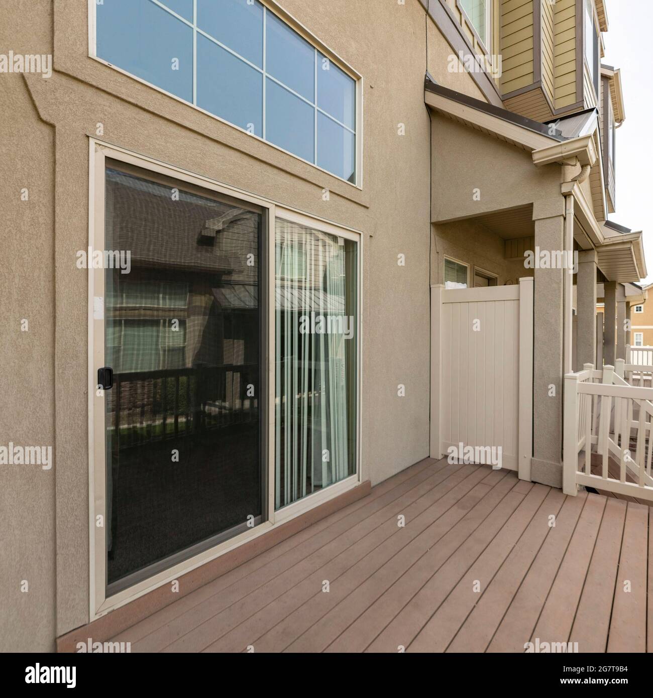 Square frame Exterior of a house on a wooden deck with sliding glass