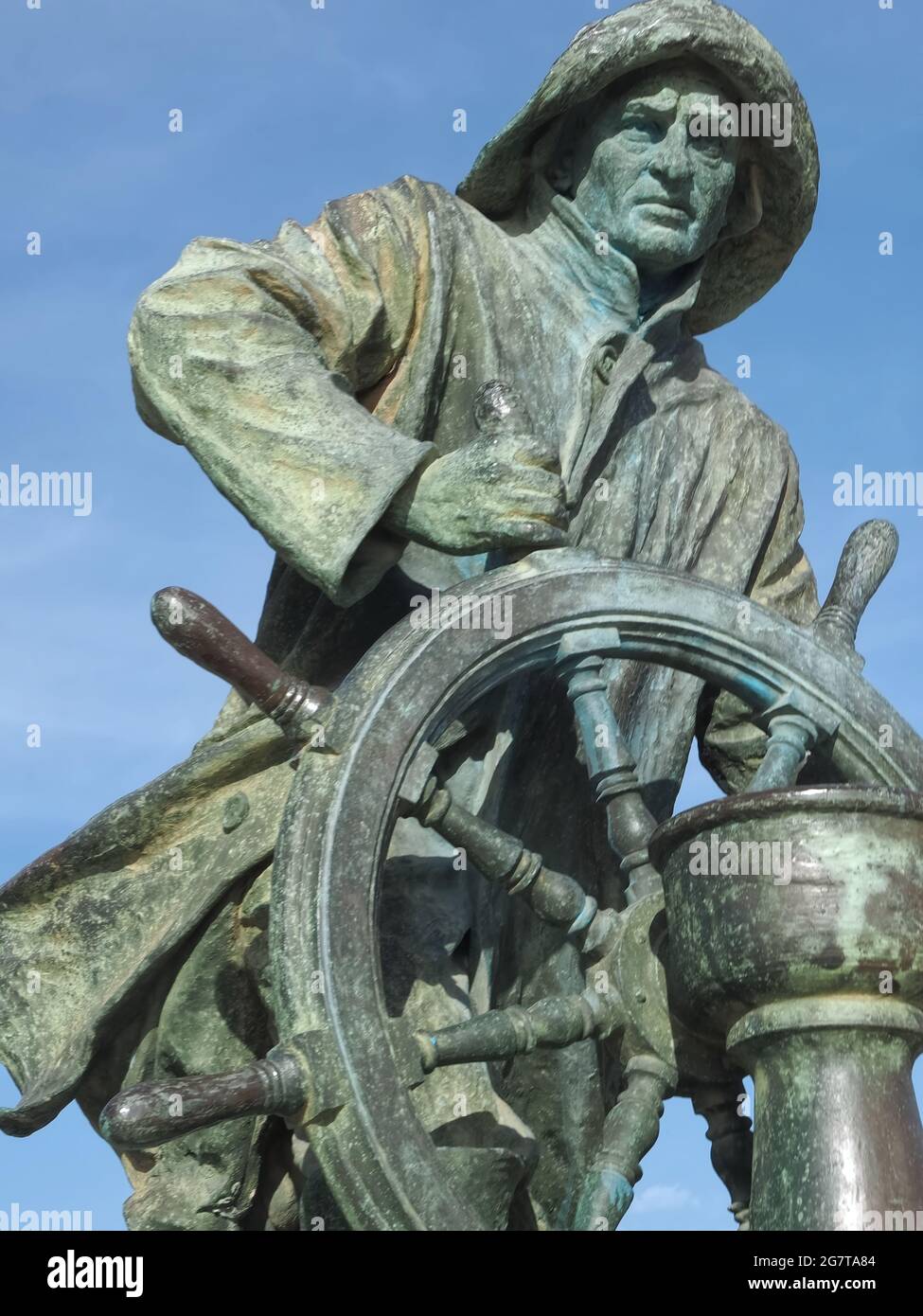 Bronze statue of a sailor with a wheel Stock Photo Alamy
