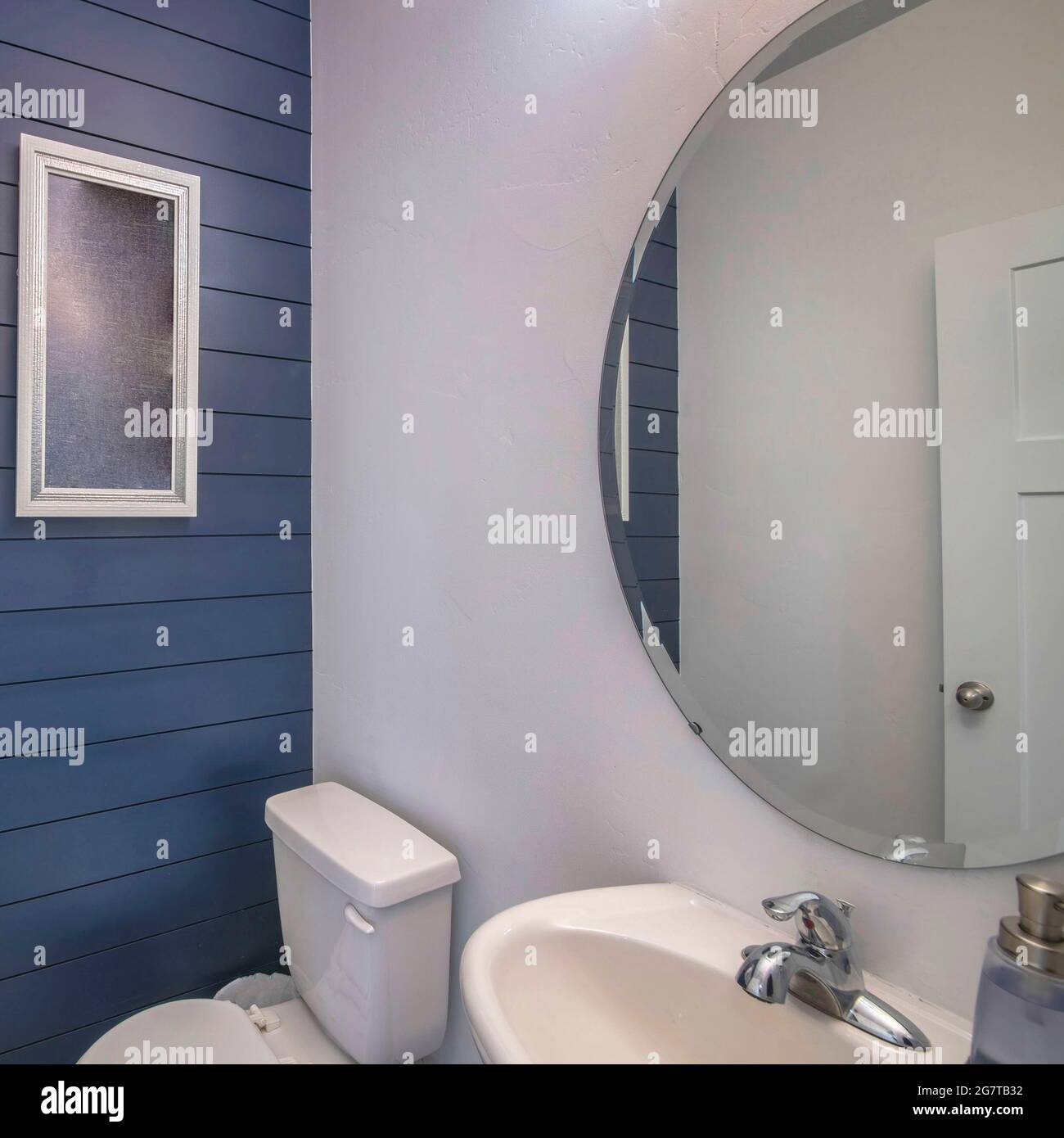 Square frame Powder room interior with blue wooden planks front wall