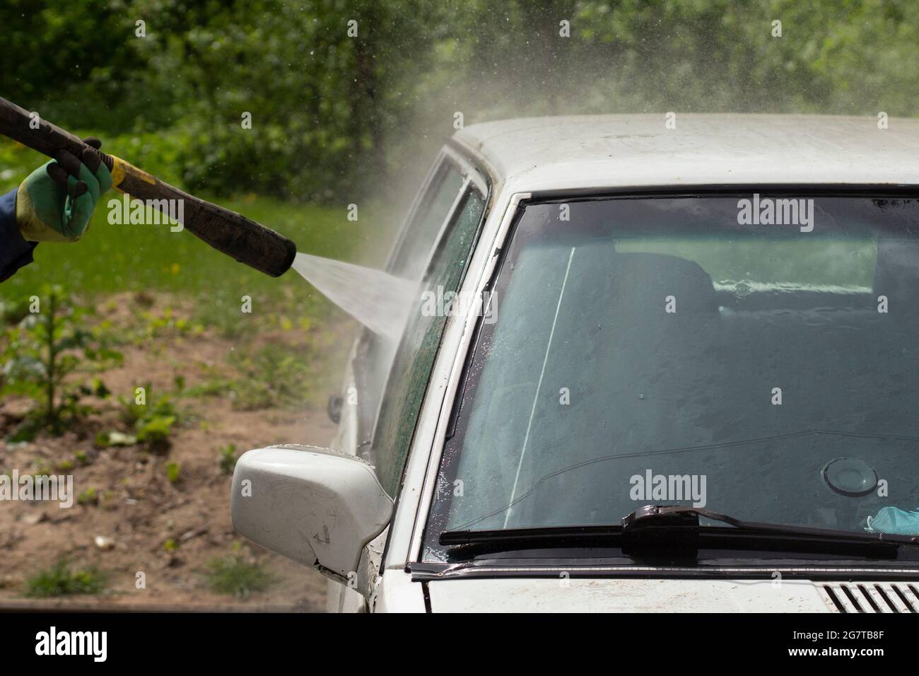 The car is washed at the car wash. Washing the car from dirt. High