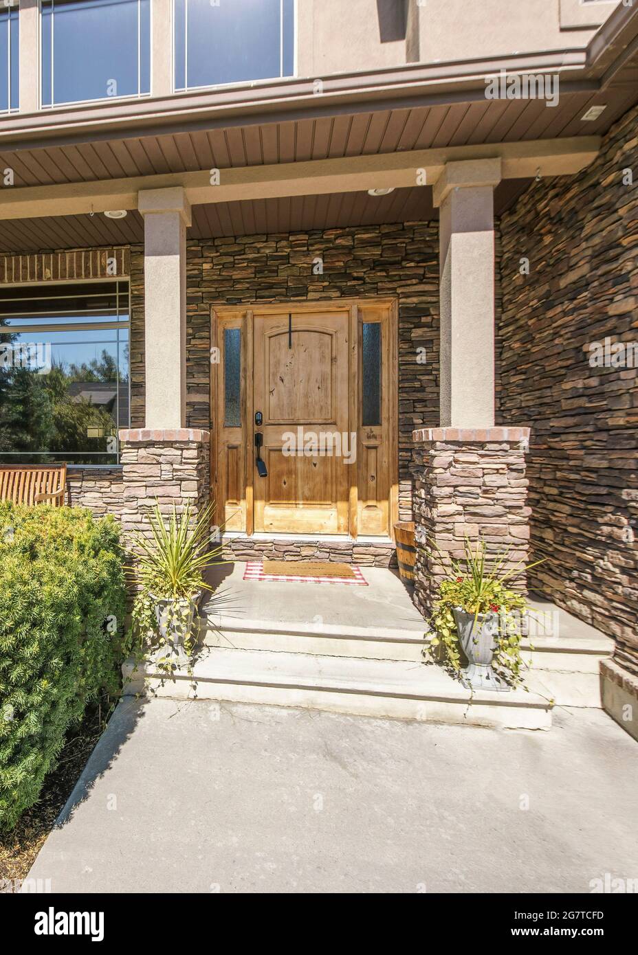 Vertical Front exterior of a two storey house with stone brick walls ...