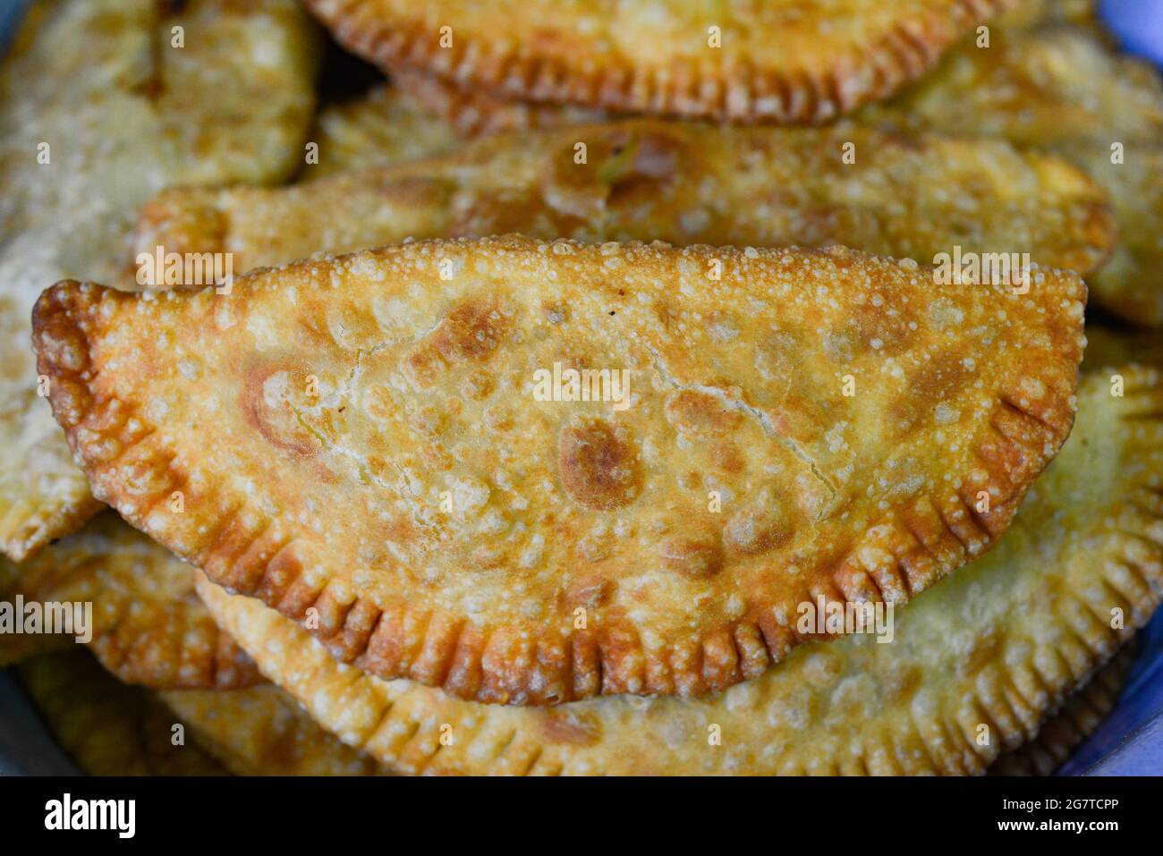 Chebureki baked on a pan in hot oil. pies with meat filling baked in hot oil. Stock Photo