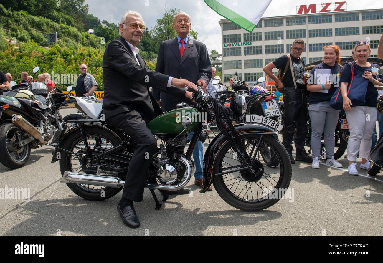 Zschopau, Germany. July 16 2021: Jörgen S. Rasmussen (l), grandson of the eponymous founder of the Zschopau engine works, sits next to Carl Hahn, former Chairman of the Board of Management of Volkswagen, on a 1936 DKW SB 200 in front of the former DKW and MZ motorcycle plant in Zschopau. Both guests of honour watched the awarding of the name 'Motorcycle City' to Zschopau. Flanked in style by hundreds of two-wheelers, mainly from DKW and MZ production, the town was now awarded the title. Motorcycles were built in the Saxon town between 1922 and 2016. Credit: dpa picture alliance/Alamy Live News Stock Photo