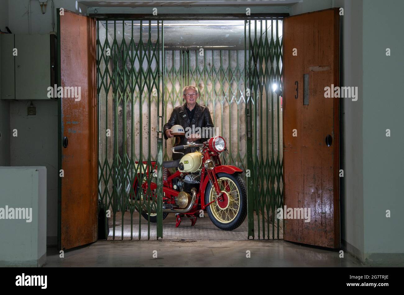Zschopau, Germany. July 16 2021: Reiner Mattheß stands at his DKW Luxus 500 in the former DKW and MZ motorcycle factory in Zschopau. The town of Zschopau has now been awarded the title of 'Motorcycle Town'. Motorcycles were built here between 1922 and 2016. With up to 85,000 machines a year, MZ was considered the largest motorcycle manufacturer in the world until 1990 and at times exported to around 100 countries. The title, which the city now bears, is intended as a reminder of the glorious times of two-wheel production, but also of the great successes in motorcycle racing. Credit: dpa pictur Stock Photo
