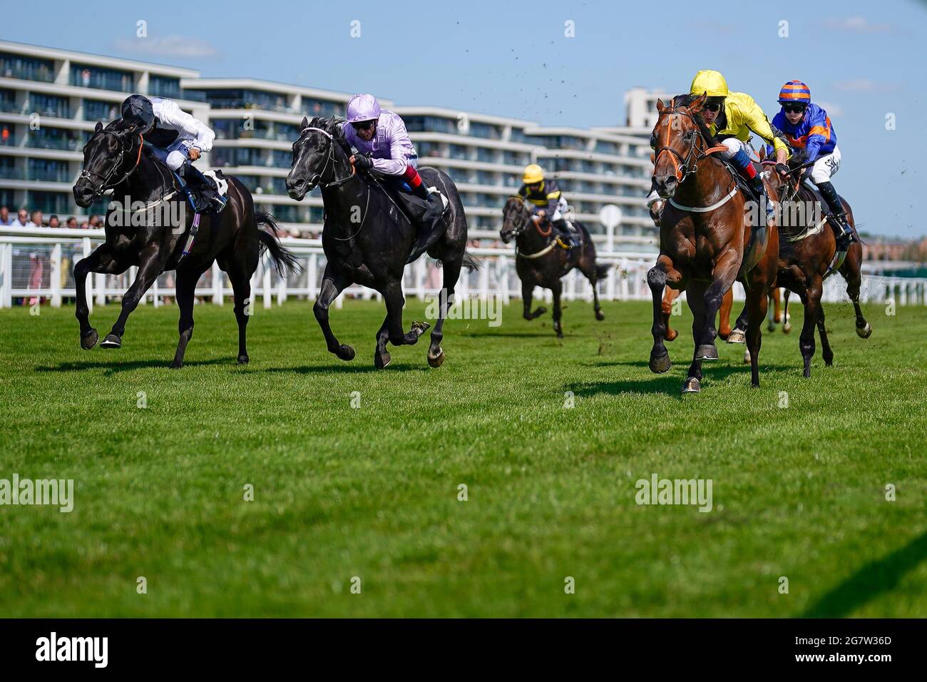 Adam Kirby riding Caturra (yellow) win The IRE Incentive, It Pays To Buy Irish Rose Bowl Stakes at Newbury Racecourse. Stock Photo