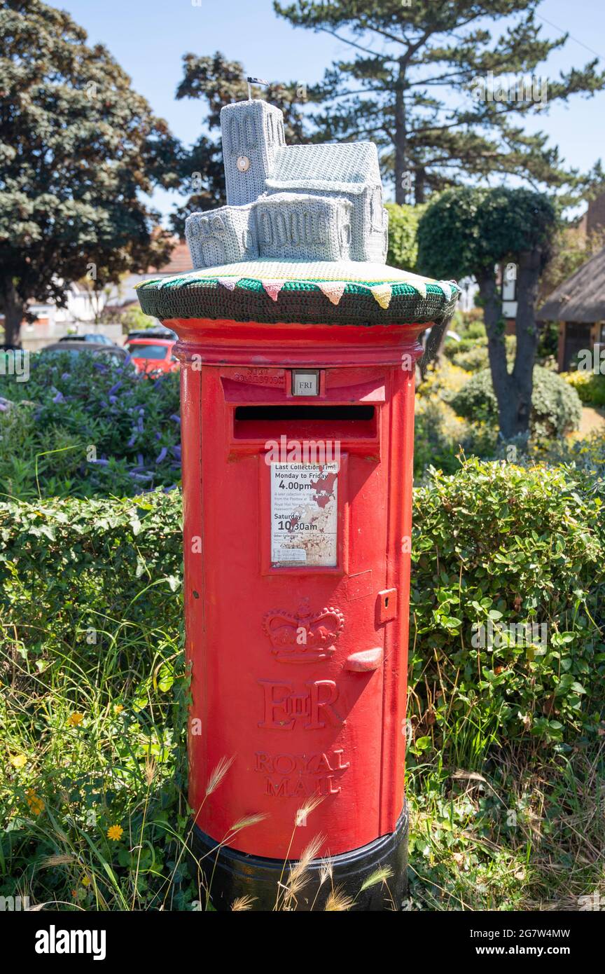 Royal Mail red postboxes with hand knitted woolen tops in appreciation of key workers through the covid 19 pandemic Stock Photo