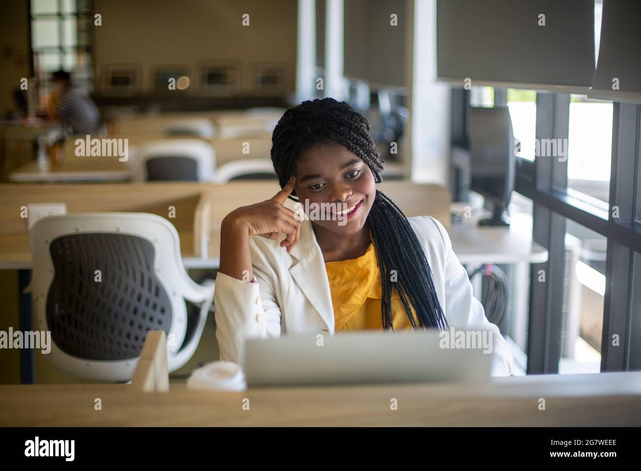 Young African American woman working using computer laptop concentrated ...
