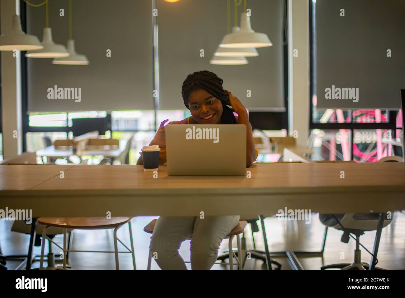 Young African American woman working using computer laptop concentrated ...