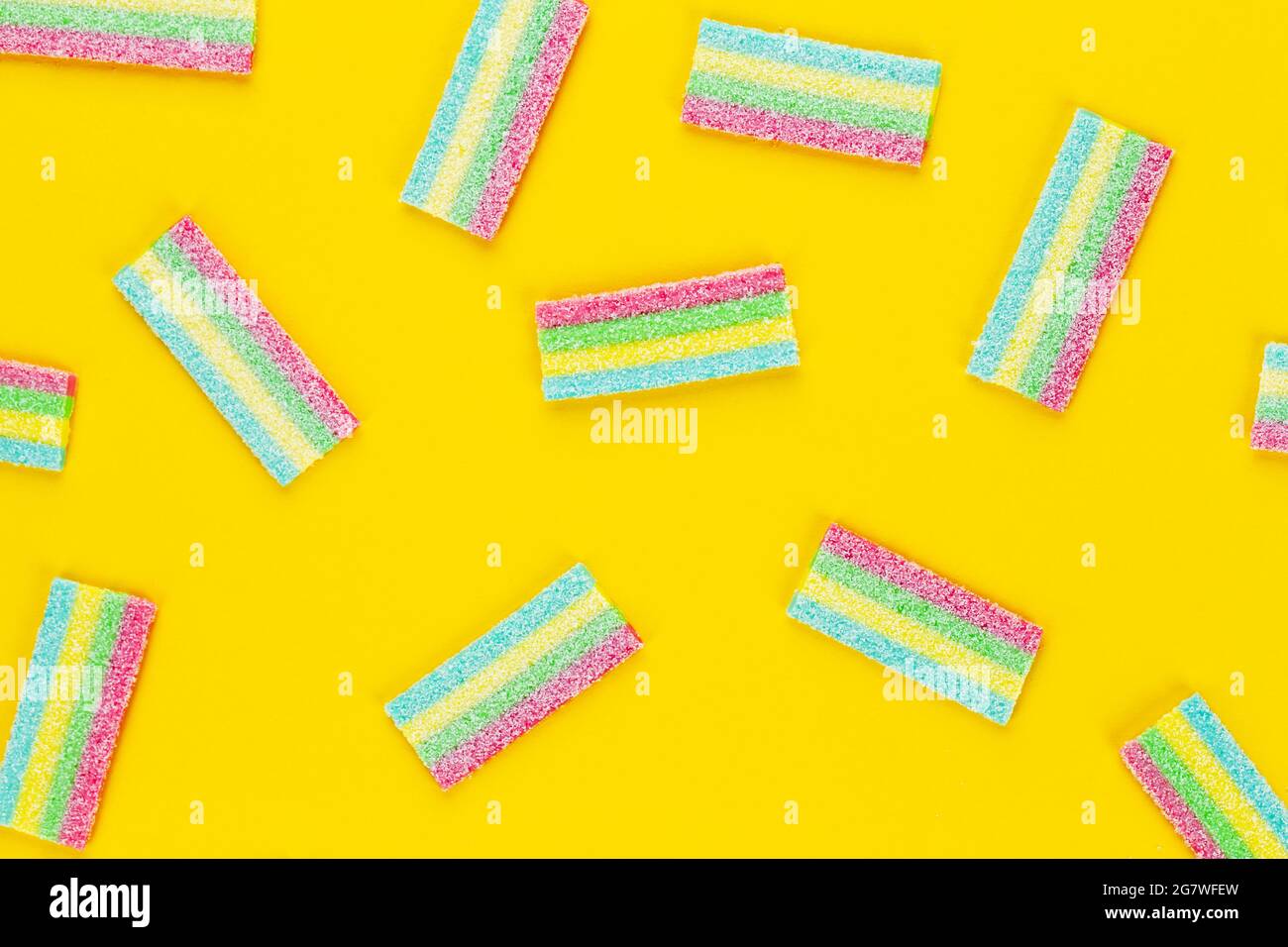 Licorice Candy. Sweet gummy sticks with different flavor, on yellow