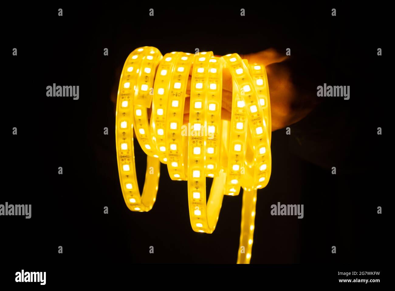 yellow led strip in hand for lighting. Stock Photo