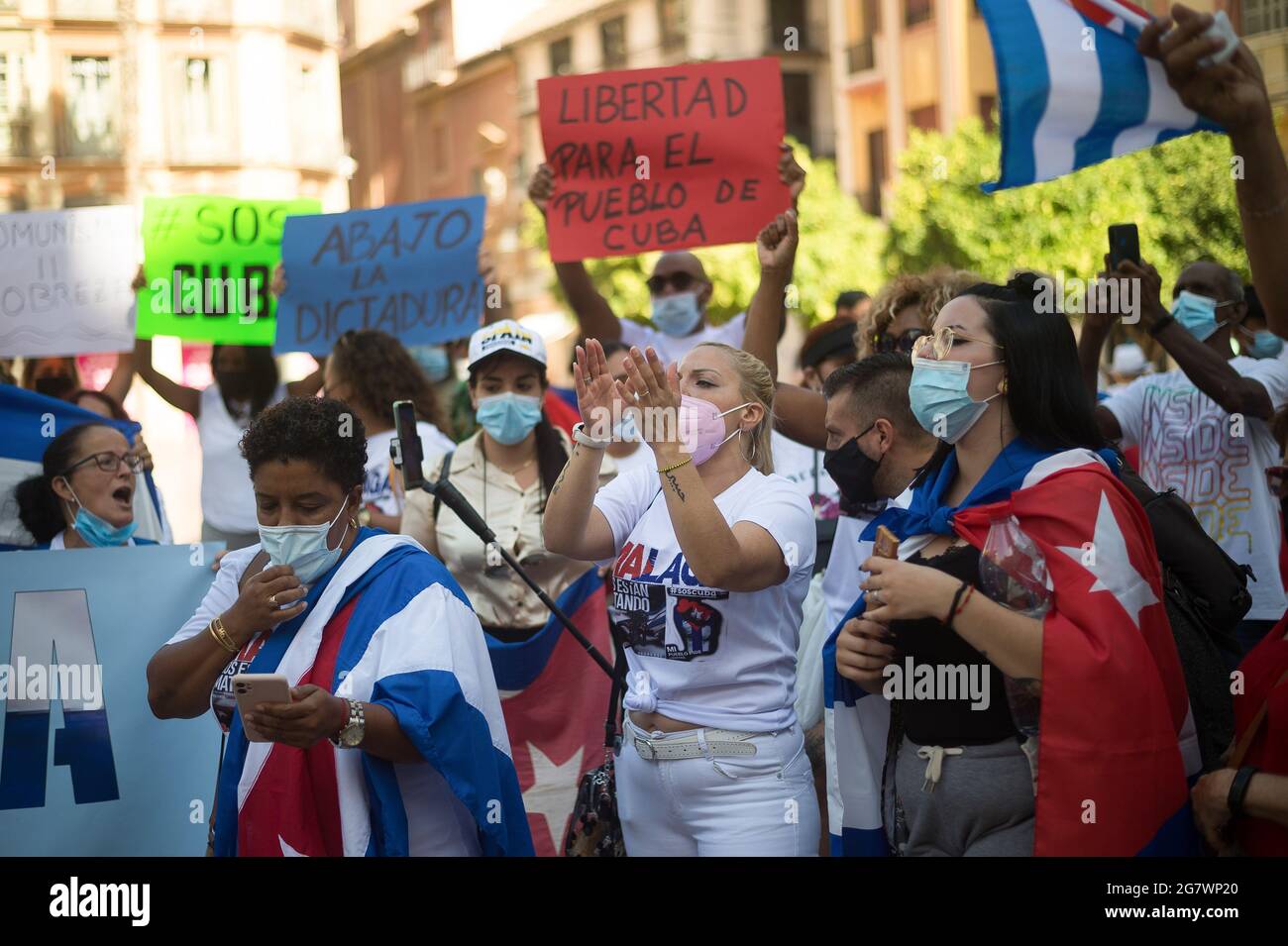 Malaga, Spain. 16th July, 2021. Protesters seen holding placards as they take part in a demonstration in support of Cuban population. A group of Cuban residents in Malaga have marched along main streets in downtown under the slogan: 'Homeland and life' to demonstrate against government of Cuban president Miguel Diaz Canel, after social breakdown in Cuba demanding the end of the communist dictatorship. Credit: SOPA Images Limited/Alamy Live News Stock Photo