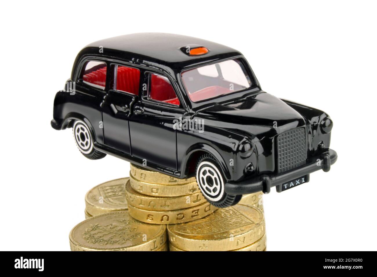 A London black Taxi cab on coins. Stock Photo