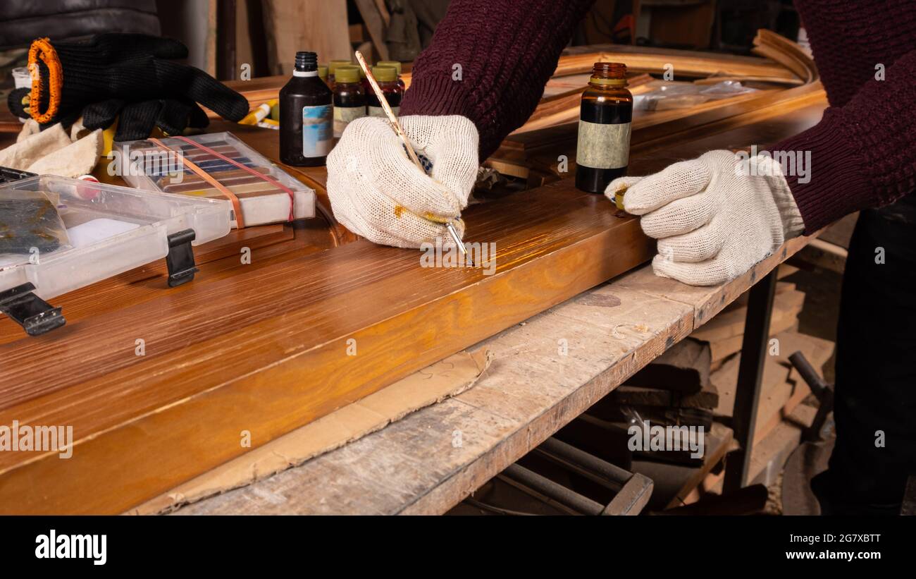 restoration of wooden doors, painting and sealing of chips. Stock Photo