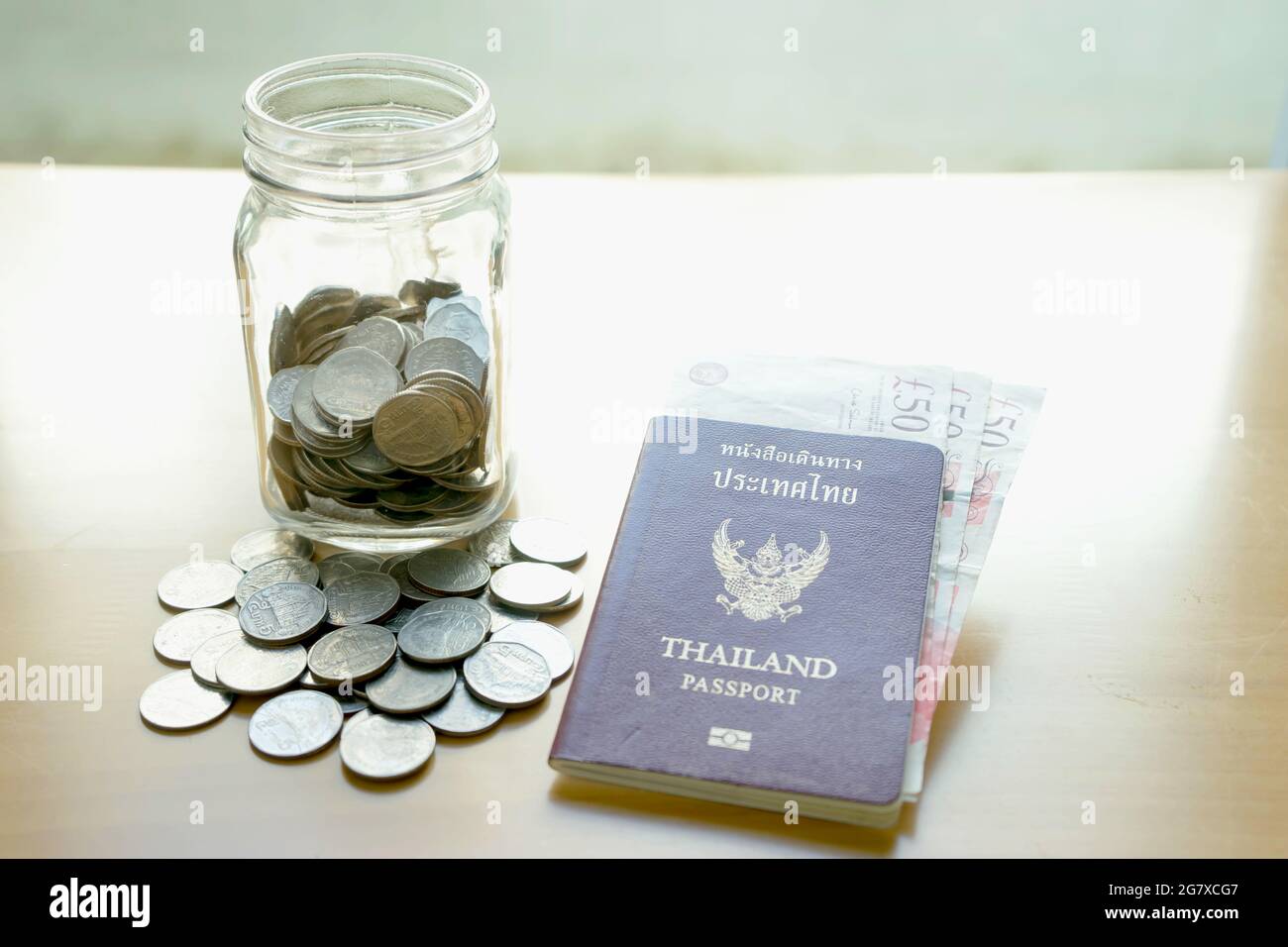 Savings jar with currency for travel Stock Photo Alamy
