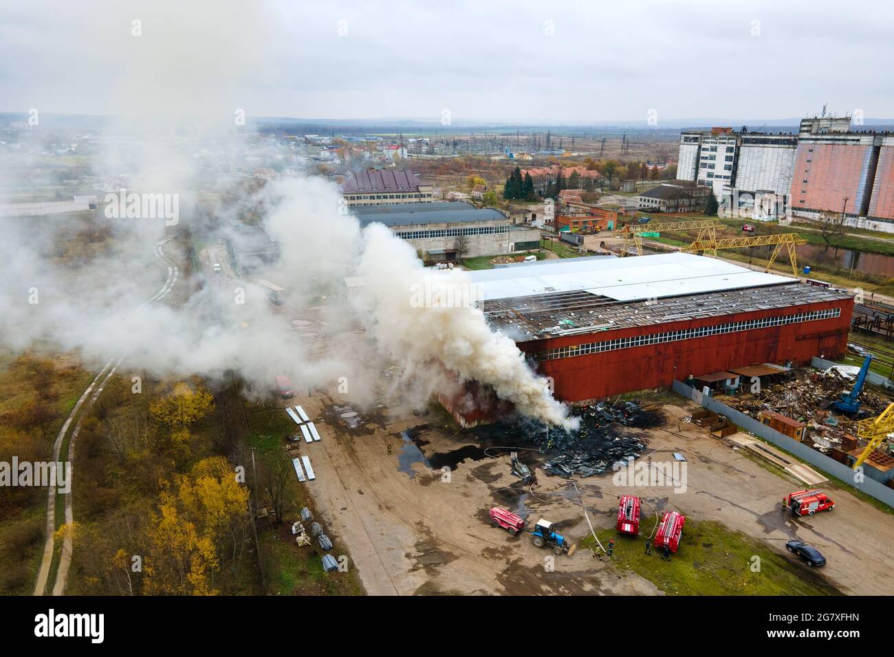 Aerial view of firefighters extinguishing fire in industrial area Stock ...