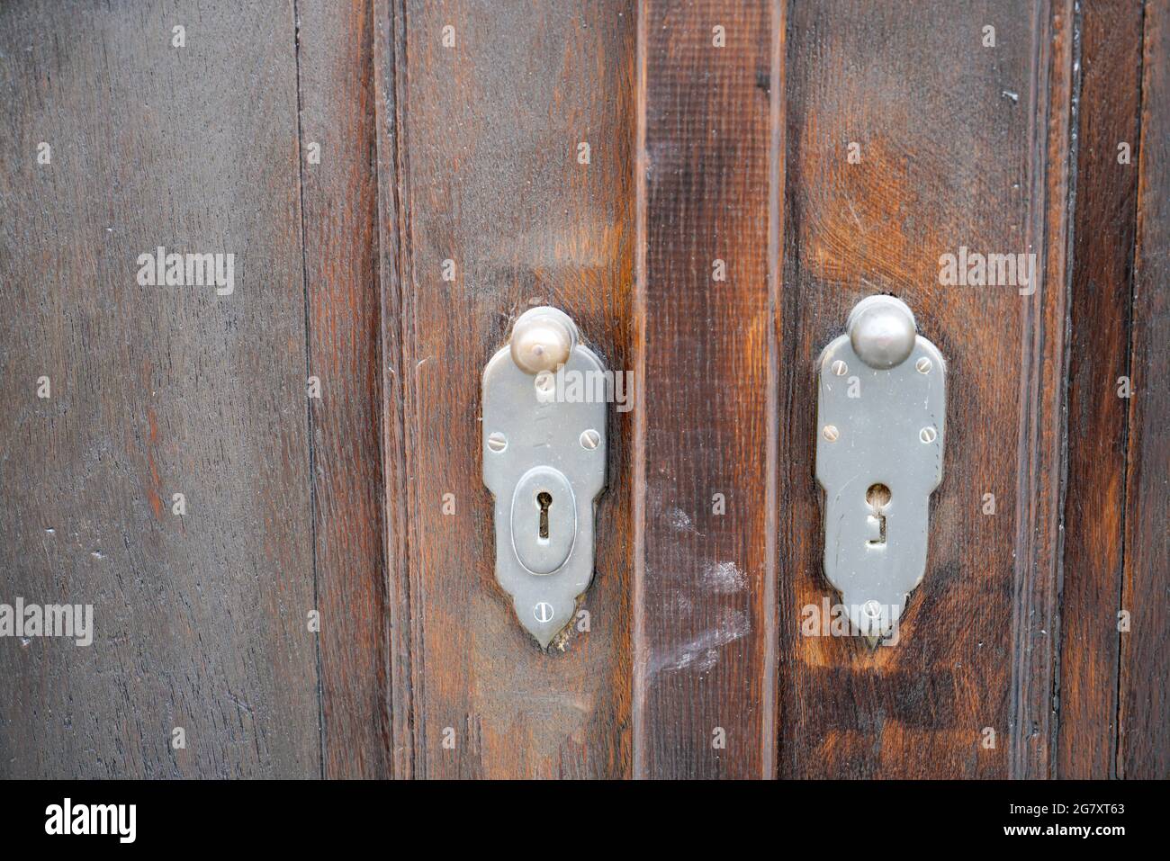 Door lock and door knocker on old doors photographed in daylight Stock Photo