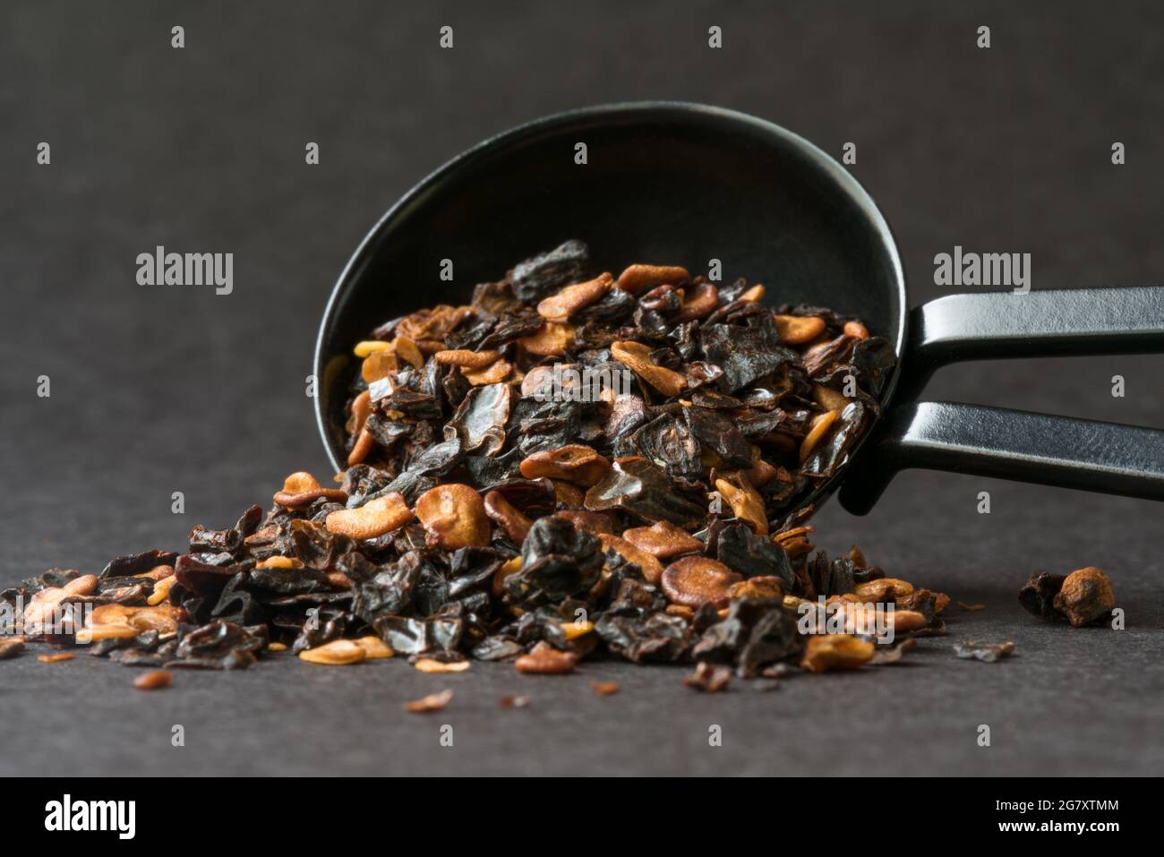 Chipotle Pepper Flakes Spilled from a Teaspoon Stock Photo