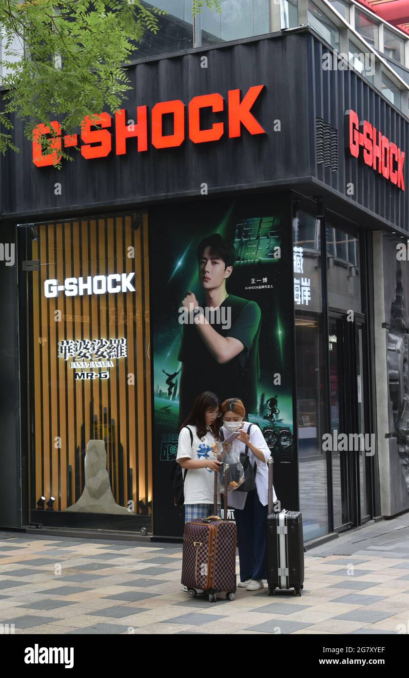 Two pedestrians in front of CASIO G Shock store. Photo by Sheldon