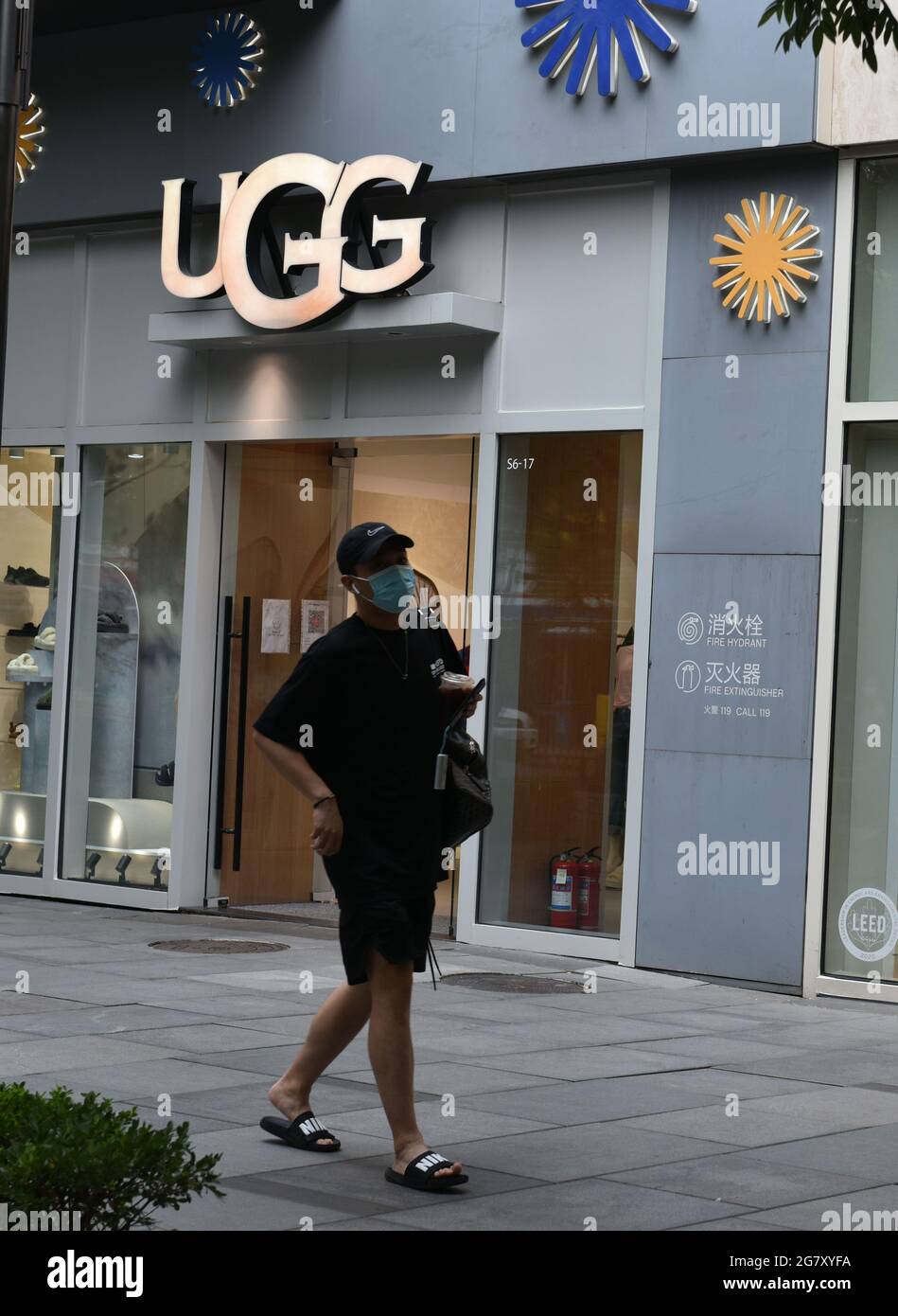 Beijing, China. 16th July, 2021. A man walks by the UGG shop. (Photo by  Sheldon Cooper/SOPA Images/Sipa USA) Credit: Sipa USA/Alamy Live News Stock  Photo - Alamy