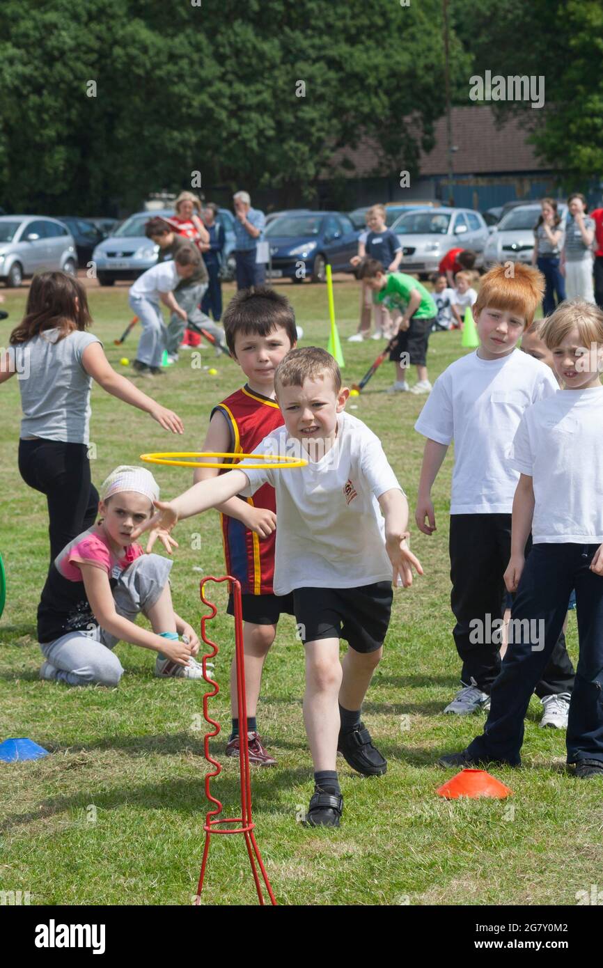 Boy playing hoopla at school sports day Stock Photo