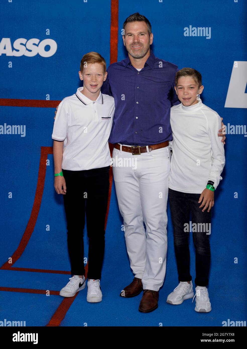WEST HOLLYWOOD, CALIFORNIA - JULY 15, 2021: US former soccer player and LA Galaxy Greg Vanney (C) attends Apple's 'Ted Lasso' Season 2 Premiere at Pac Stock Photo
