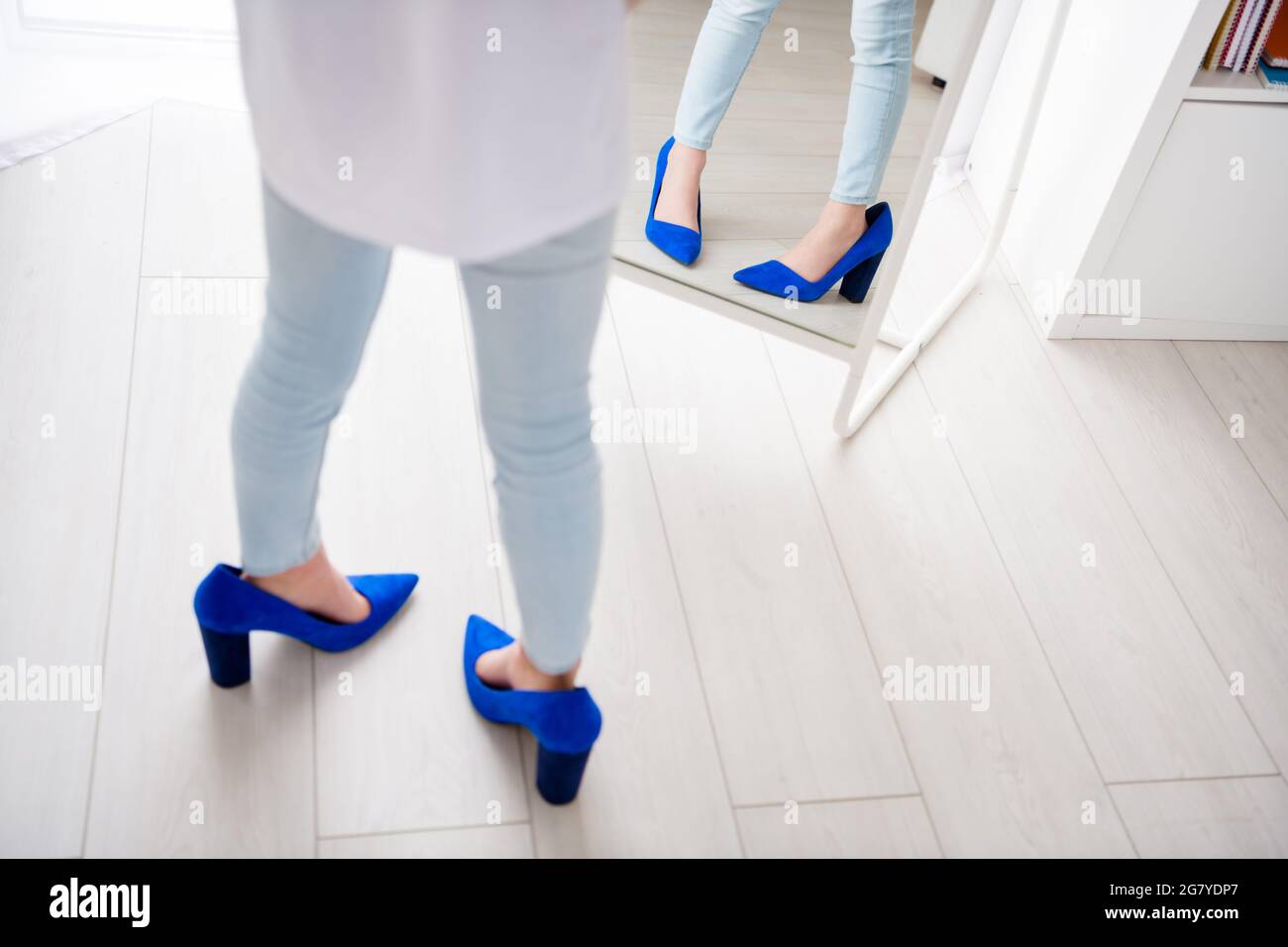 Cropped photo of young little kid girl wearing mother shoes high-heels oversized imitate growth lady mirror indoors Stock Photo