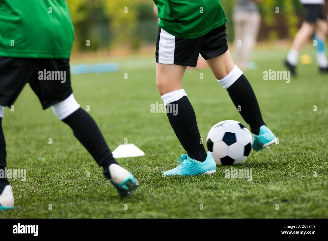 Legs of Soccer Players Kicking Balls on Training Pitch. Football Soccer