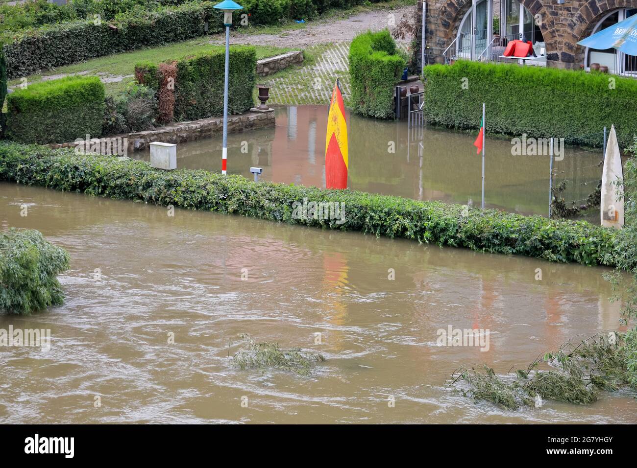 Hattingen, NRW, Germany. 16th July, 2021. Decorative surfboards in what used to be the outdoor restaurant seating of Hotel 'An der Kost'. The River Ruhr has flooded its embankment, fields and