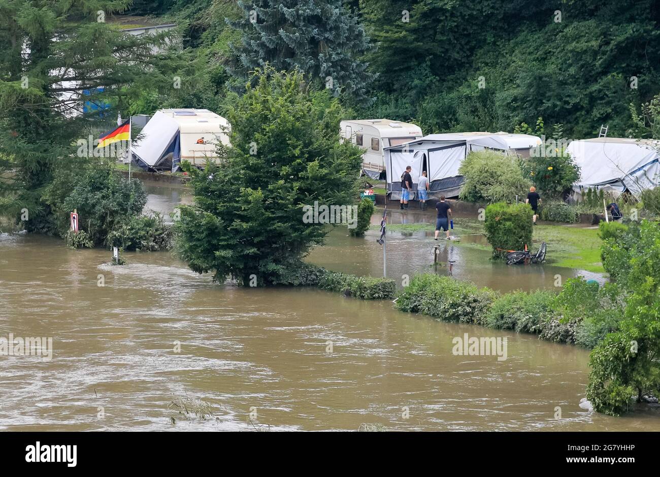 Hattingen, NRW, Germany. 16th July, 2021. Campers at 'An der Kost' campside  have moved their vans to higher ground and battle the substantial water  damage caused. The River Ruhr has flooded its