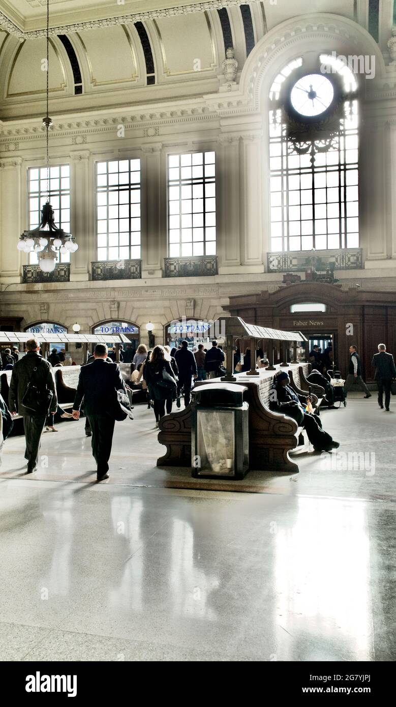 Commuters walking across the main waiting room at the Hoboken train