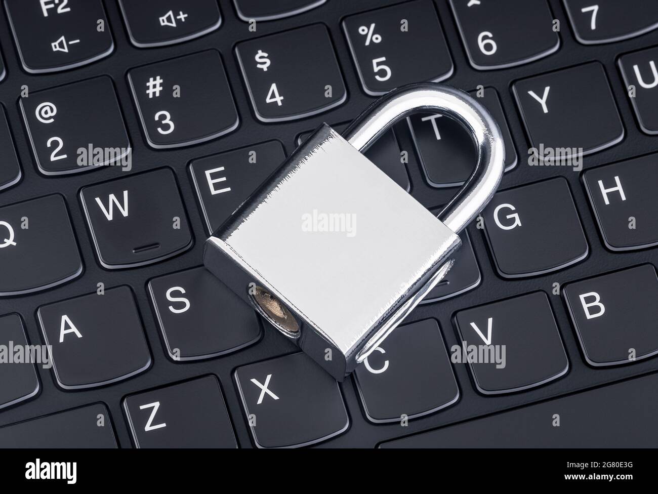 Computer security concept. Silver padlock on black laptop keyboard Stock Photo