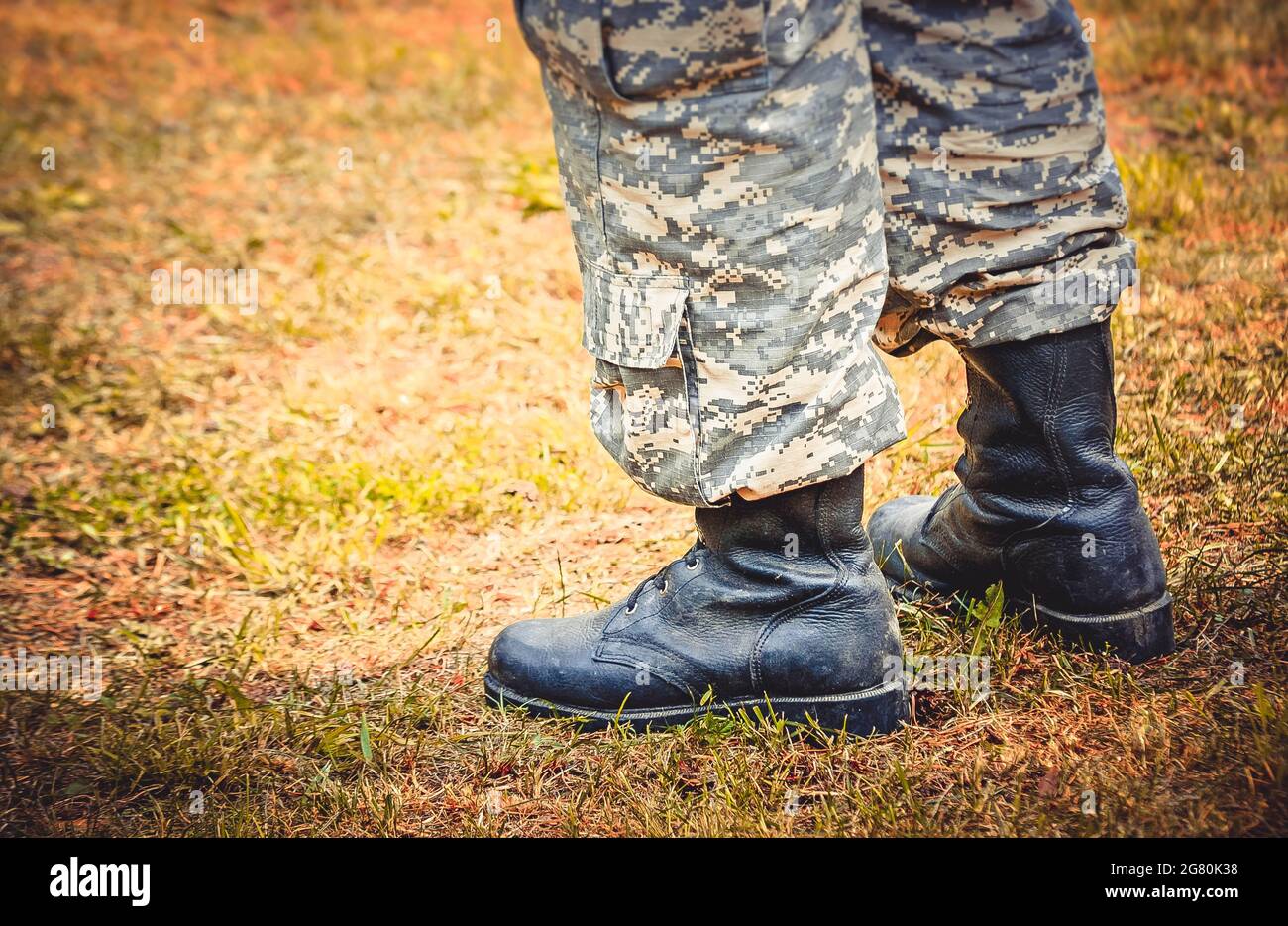 man stands in military boots and trousers Stock Photo