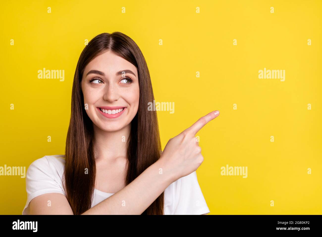 Portrait of attractive cheerful girl showing copy space offer ad like ...