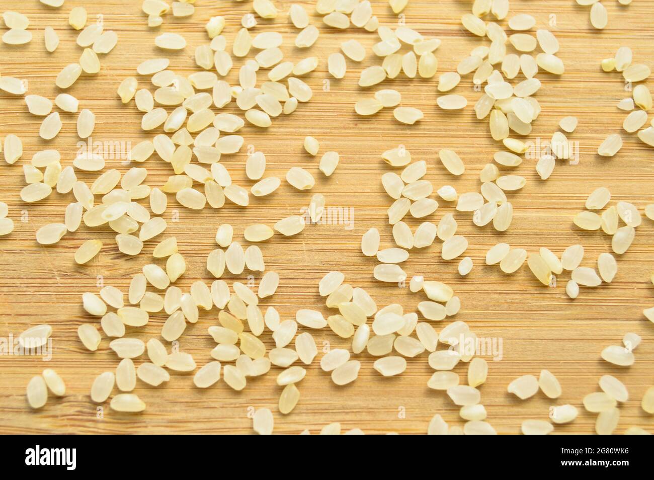 Fresh organic white raw dried rice grains texture, on bamboo cutting ...