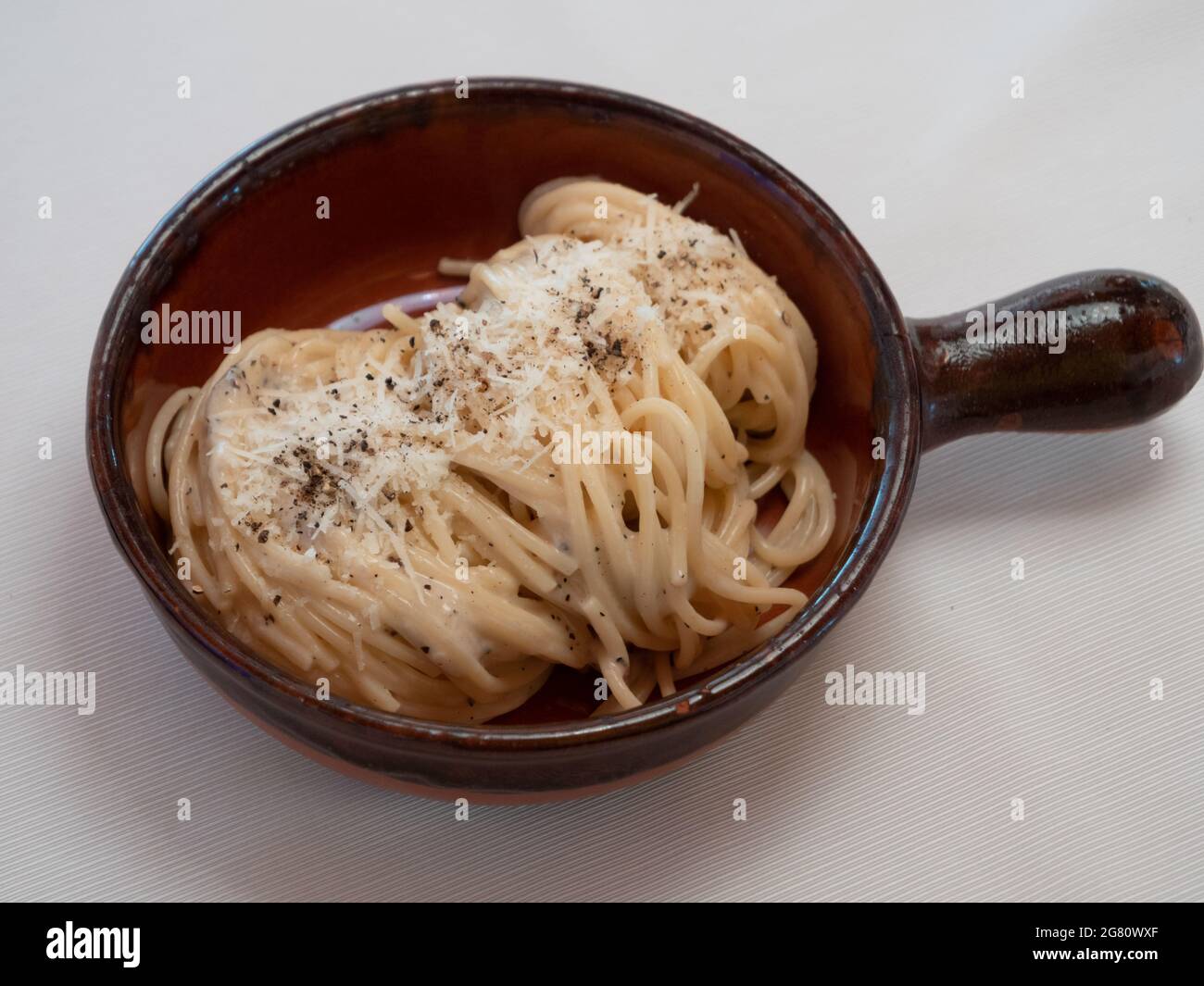 Spaghetti Cacio e Pepe with Italian Pasta with Pecorino Cheese and Pepper Stock Photo