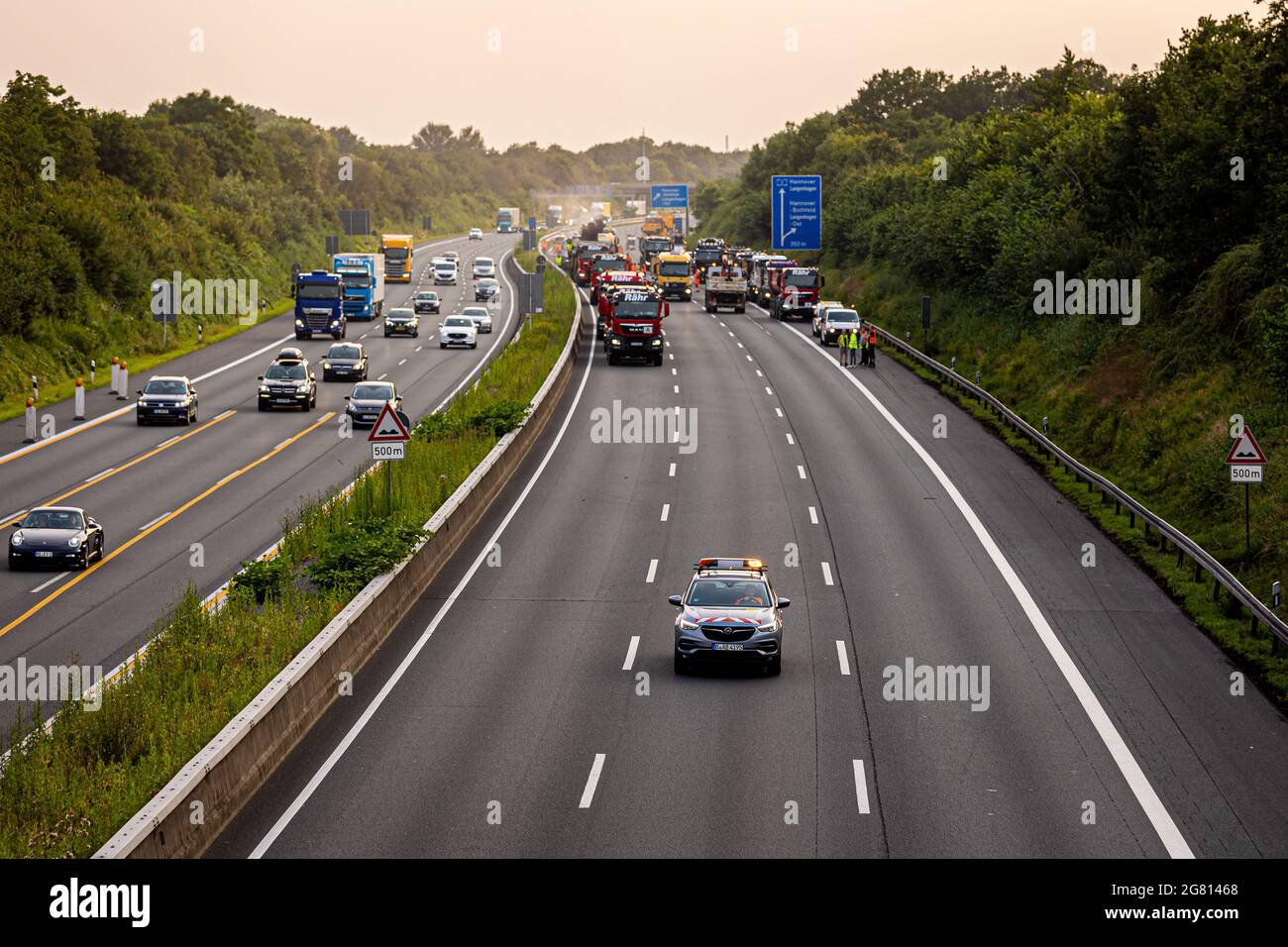 Hanover, Germany. 16th July, 2021. Numerous construction vehicles are parked on motorway 2, where around three kilometres of road are to be renewed within 57 hours. The full closure spares car and truck drivers a three-week construction site. Credit: Moritz Frankenberg/dpa/Alamy Live News Stock Photo