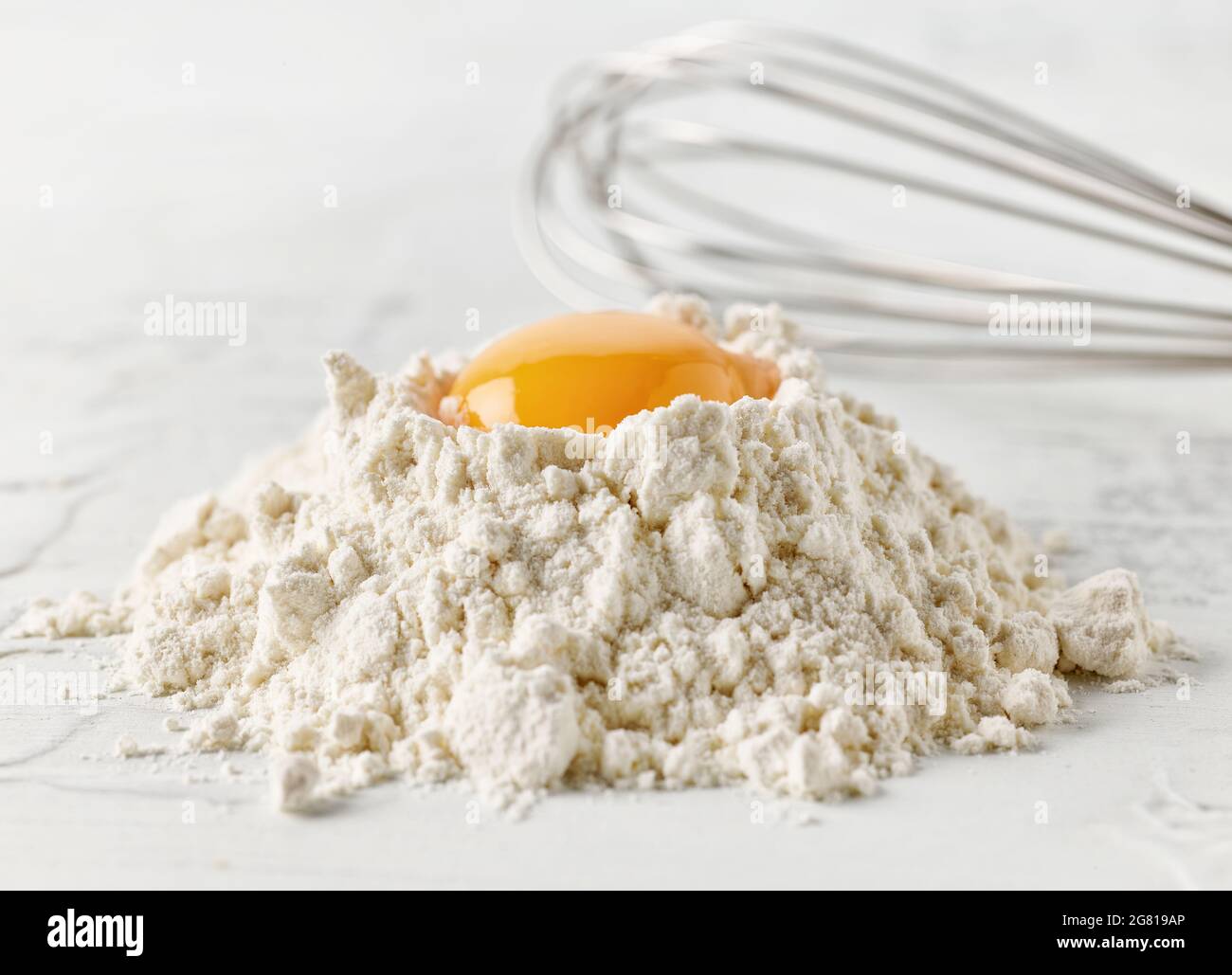 flour and egg yolk on white kitchen table Stock Photo Alamy