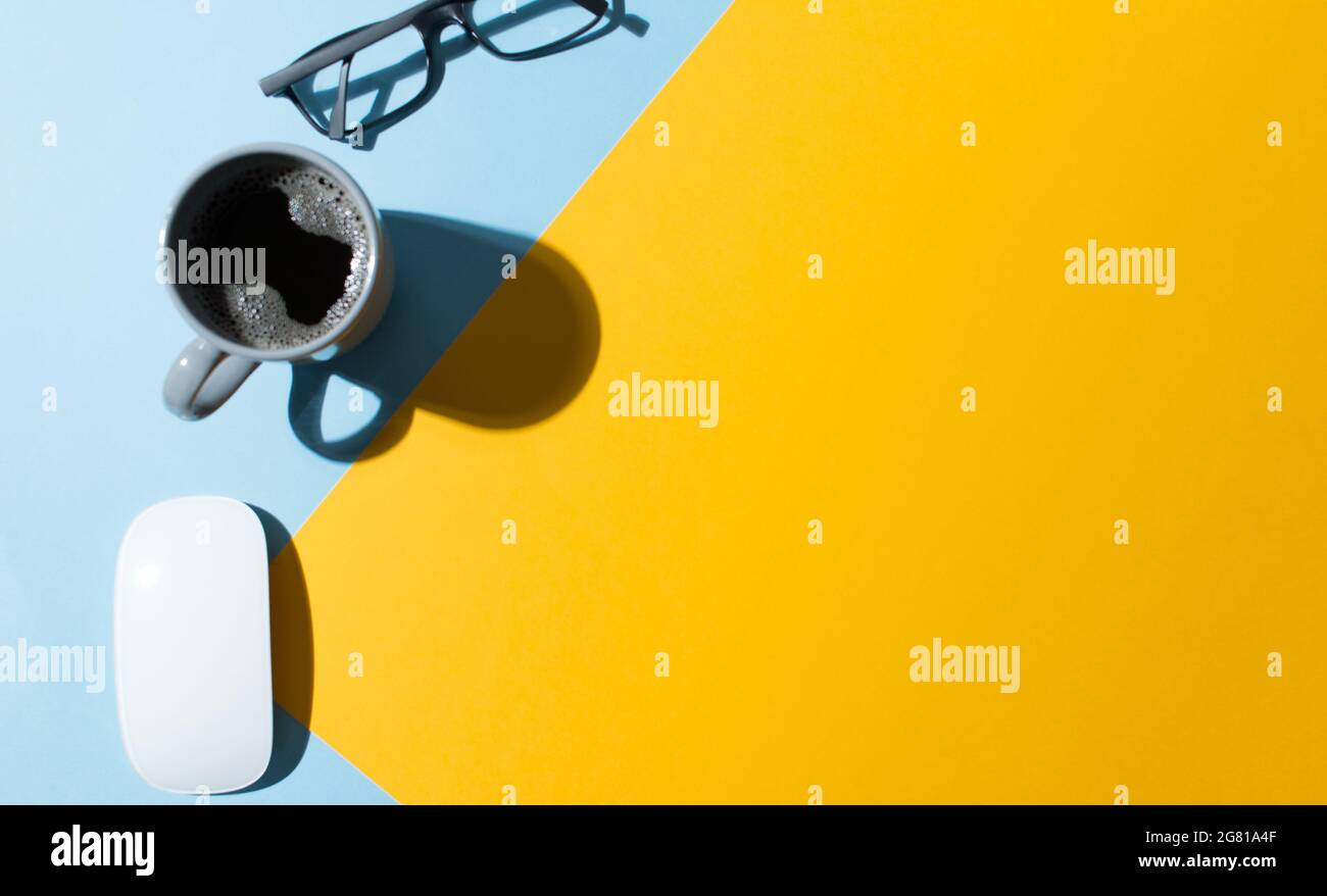 Work table with a blue and yellow background Stock Photo - Alamy