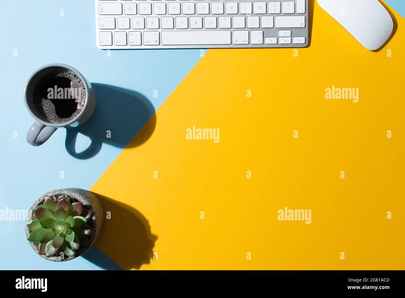 Work table with a blue and yellow background Stock Photo - Alamy