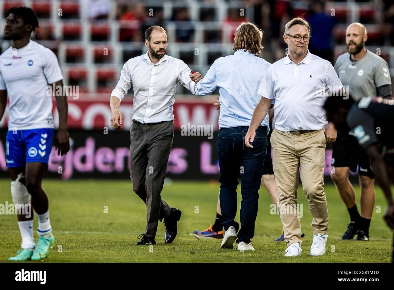 Herning, Denmark. 16th July, 2021. Head coach Andreas Alm (L) of Odense  Boldklub greets head coach Bo Henriksen of FC Mitjylland after the 3F  Superliga match between FC Midtjylland and Odense Boldklub