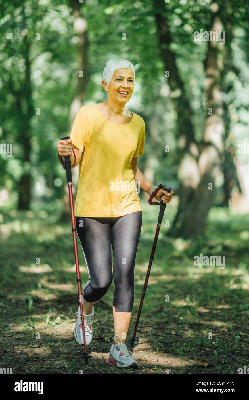 Mature woman walk poles hi-res stock photography and images - Alamy
