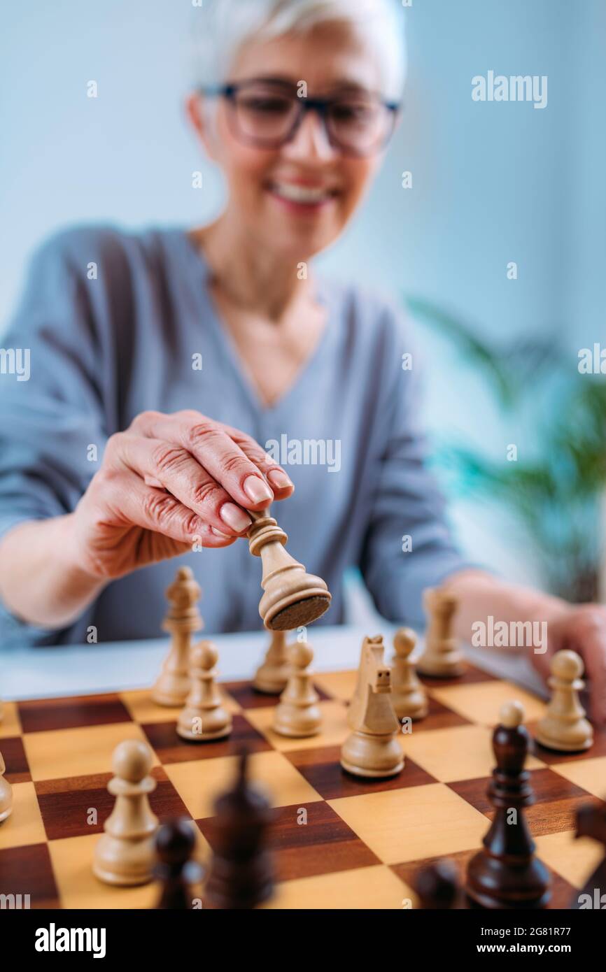 Senior woman playing chess Stock Photo