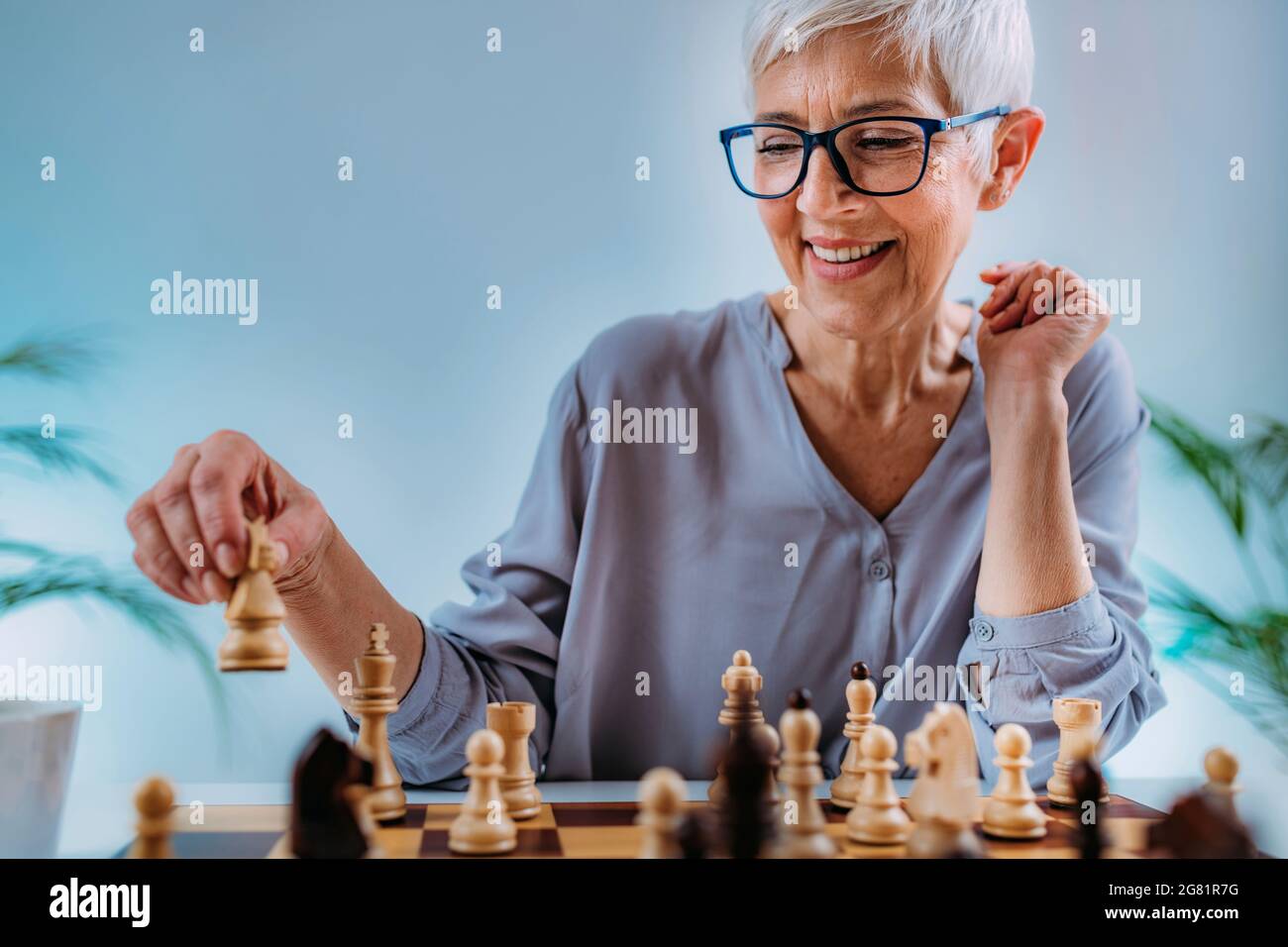 Senior woman playing chess Stock Photo
