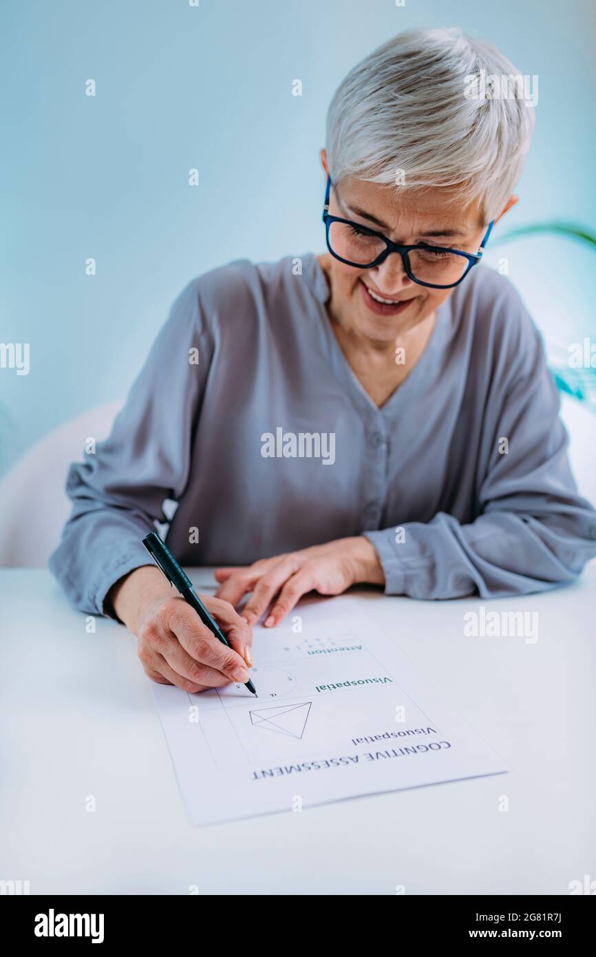 Senior woman doing cognitive function test Stock Photo