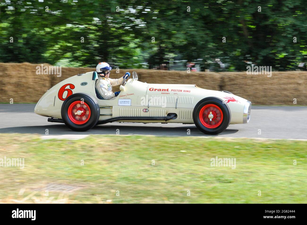 1952 Ferrari 375 'Grant Piston Ring Special' racing up the hill climb at the Goodwood Festival of Speed 2013. Grand Prix car adapted to race Indy 500 Stock Photo