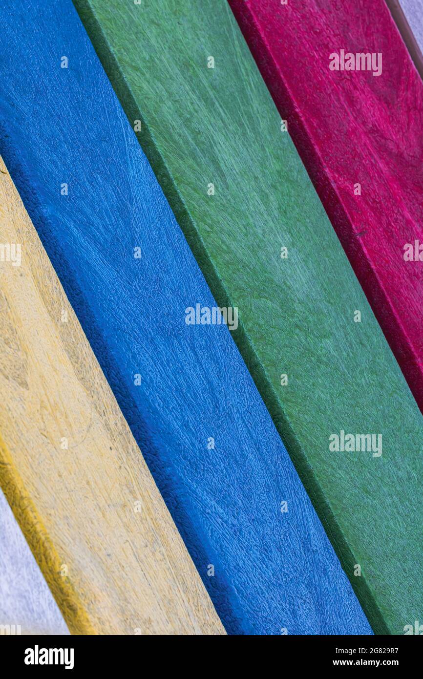 Vertical of multi-colored faux wood composite planks on an angle. Striped pattern Stock Photo
